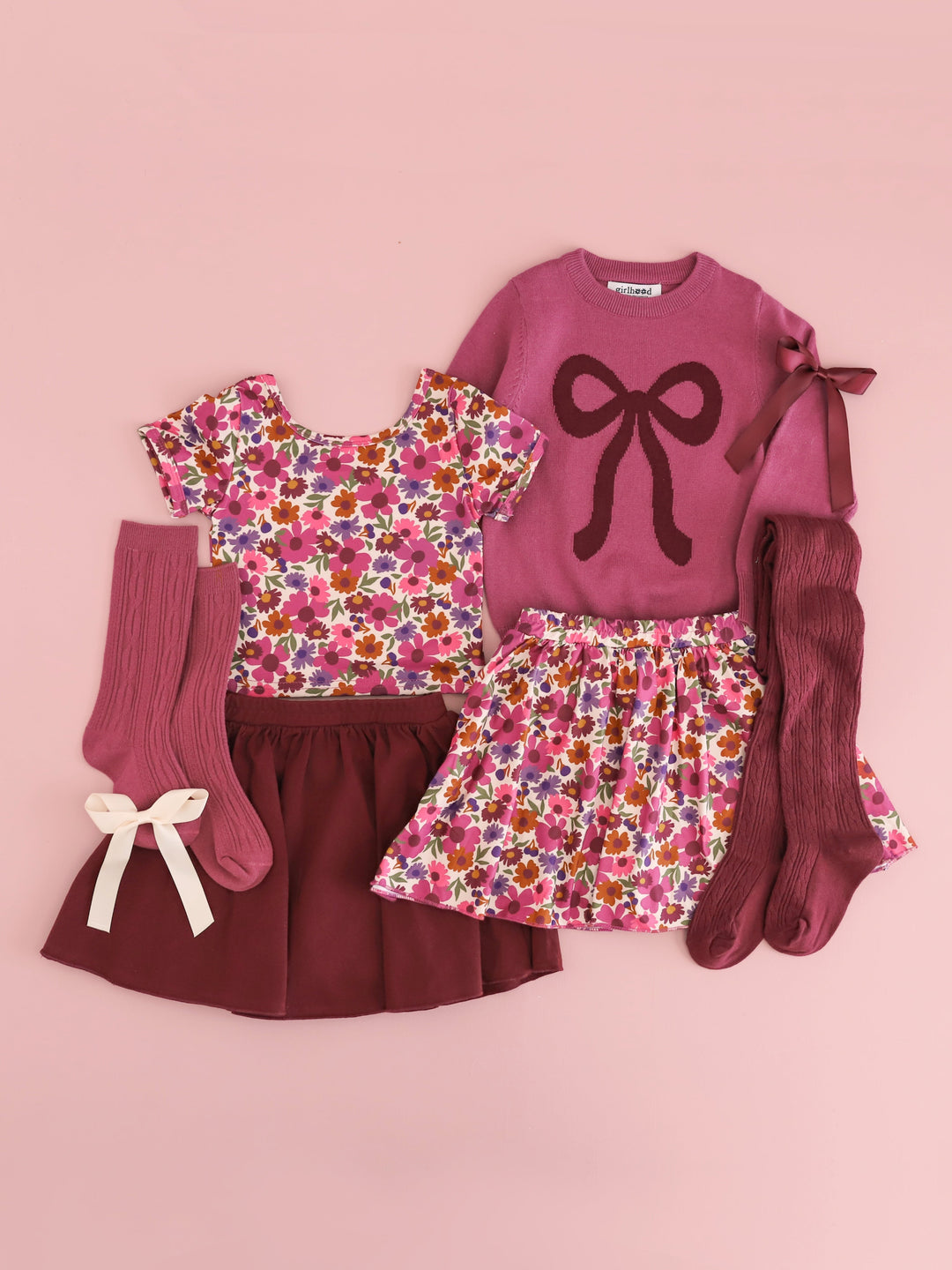 flat lay in shades of mauve and burgundy including autumn floral top and skort, solid burgundy skort, mulberry bow sweater with matching tights, socks and bows for fall