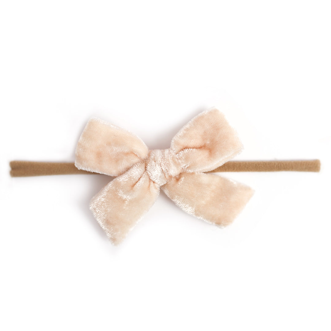 vanilla velvet bow attached to nylon headband for baby