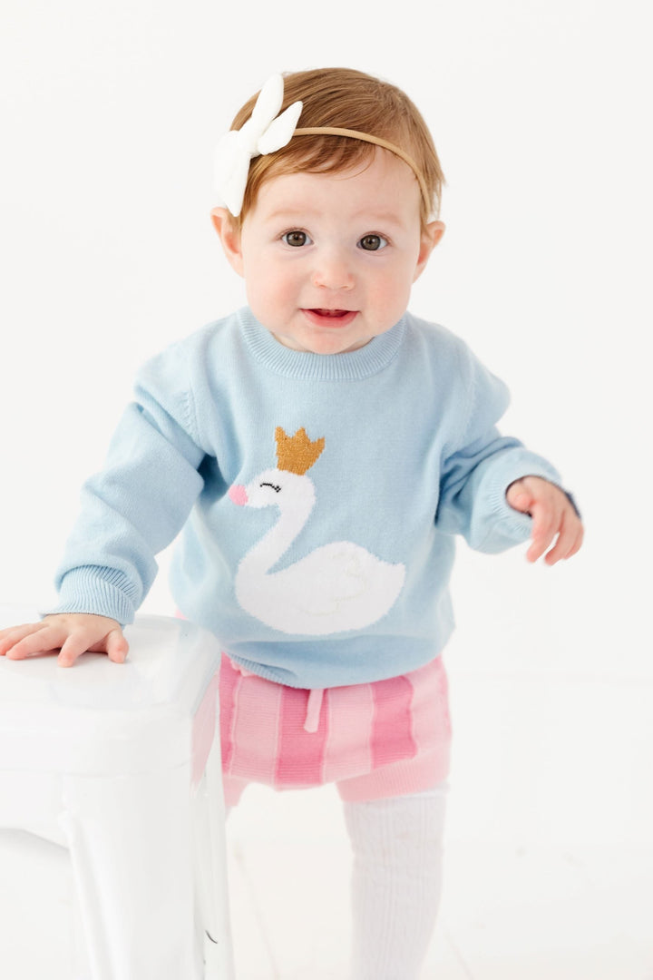 baby girl wearing swan knit sweater with matching pink knit bloomers