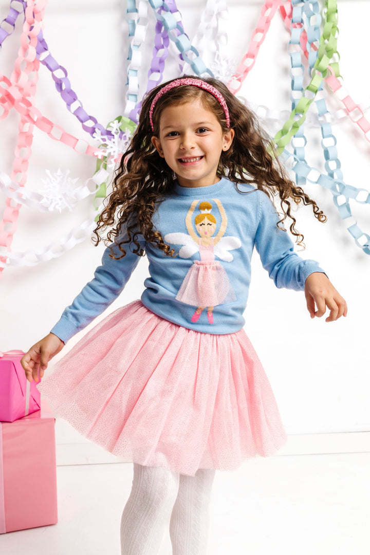 little girl in blue pullover sweater with sugarplum fairy design and matching pink sparkly tutu