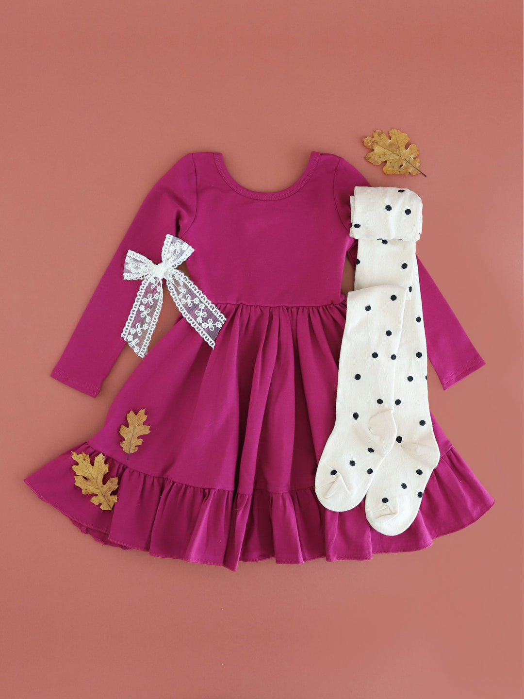 girl's raspberry cotton blend long sleeve twirl dress paired with ivory tights with black polka dots and ivory lace bow for fall