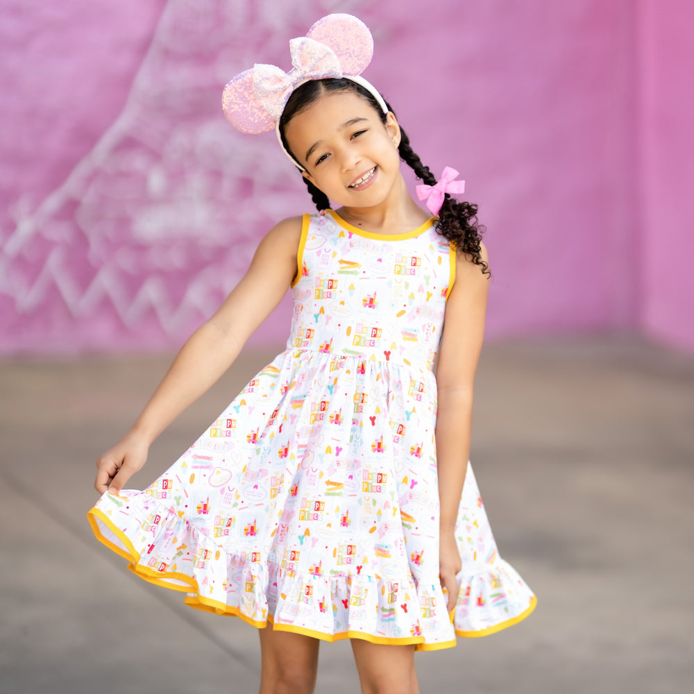 little girl wearing pink minnie mouse ears and disney inspired summer dress