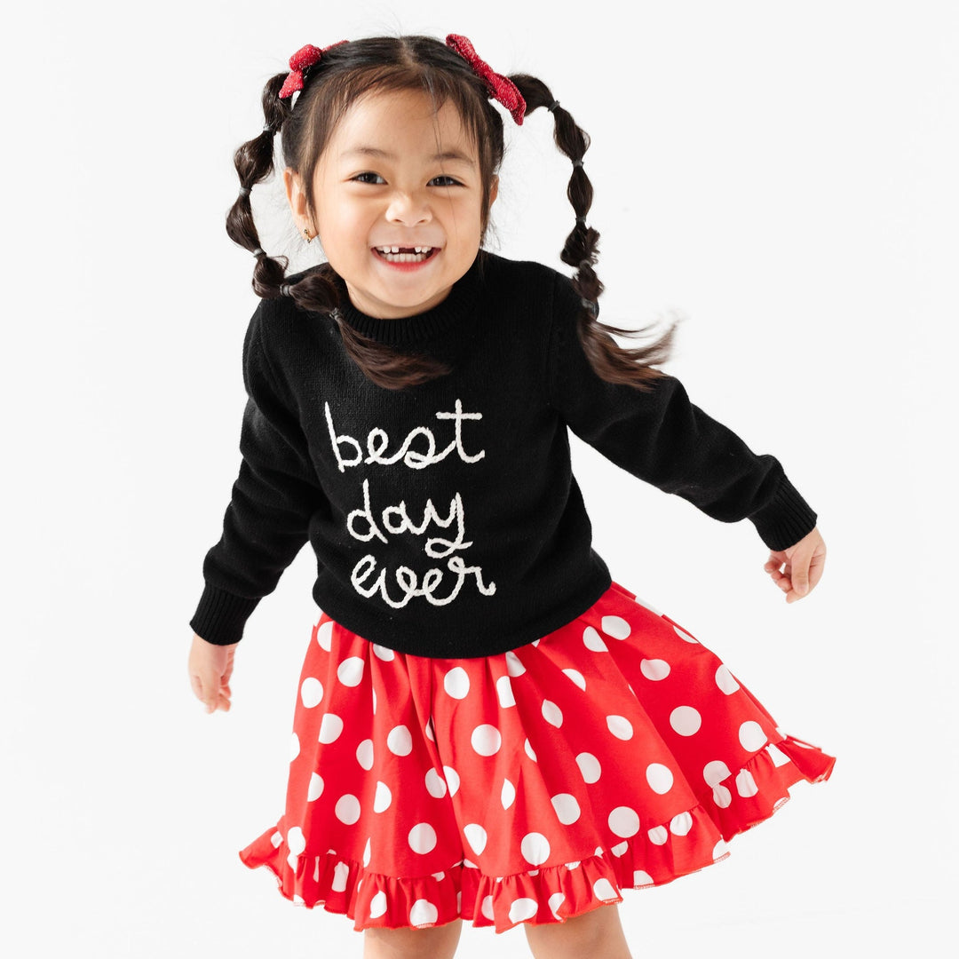 little girl in minnie dress topped with black best day ever sweater