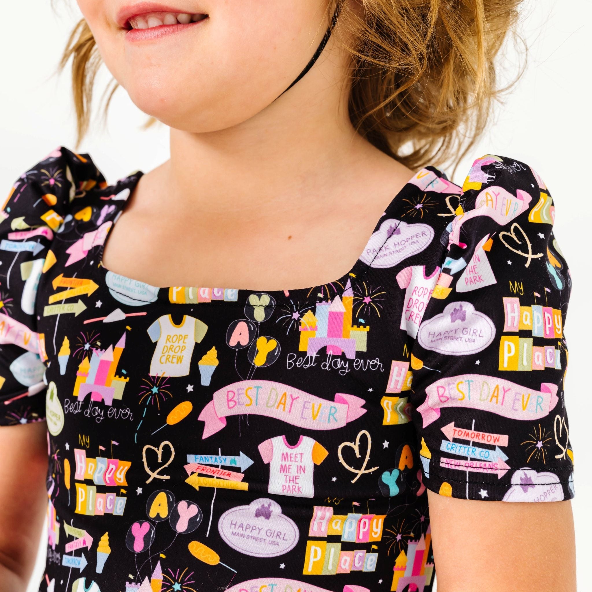 closeup of little girls' puffed sleeve on black best day ever print twirl dress 
