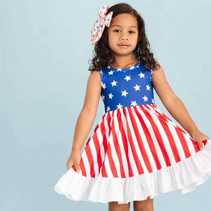 little girl wearing american flag inspired twirl dress for the 4th of july