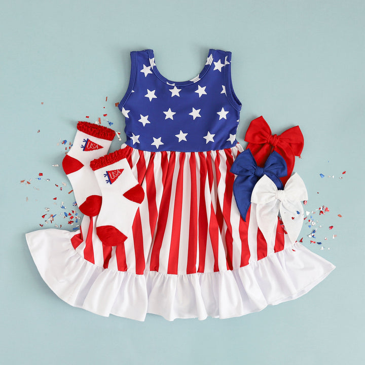 styled outfit of american flag inspired girls summer dress with USA socks and red, white and blue linen hair bows