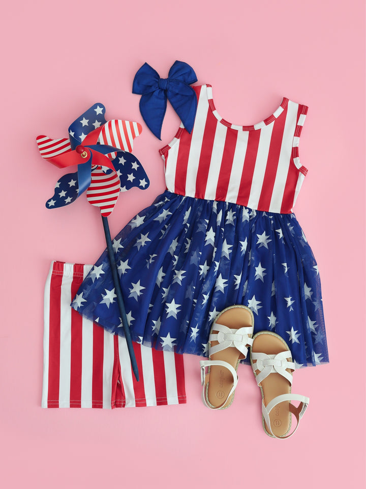 flatlay of girls 4th of july tutu set with matching shorts and blue hairbow