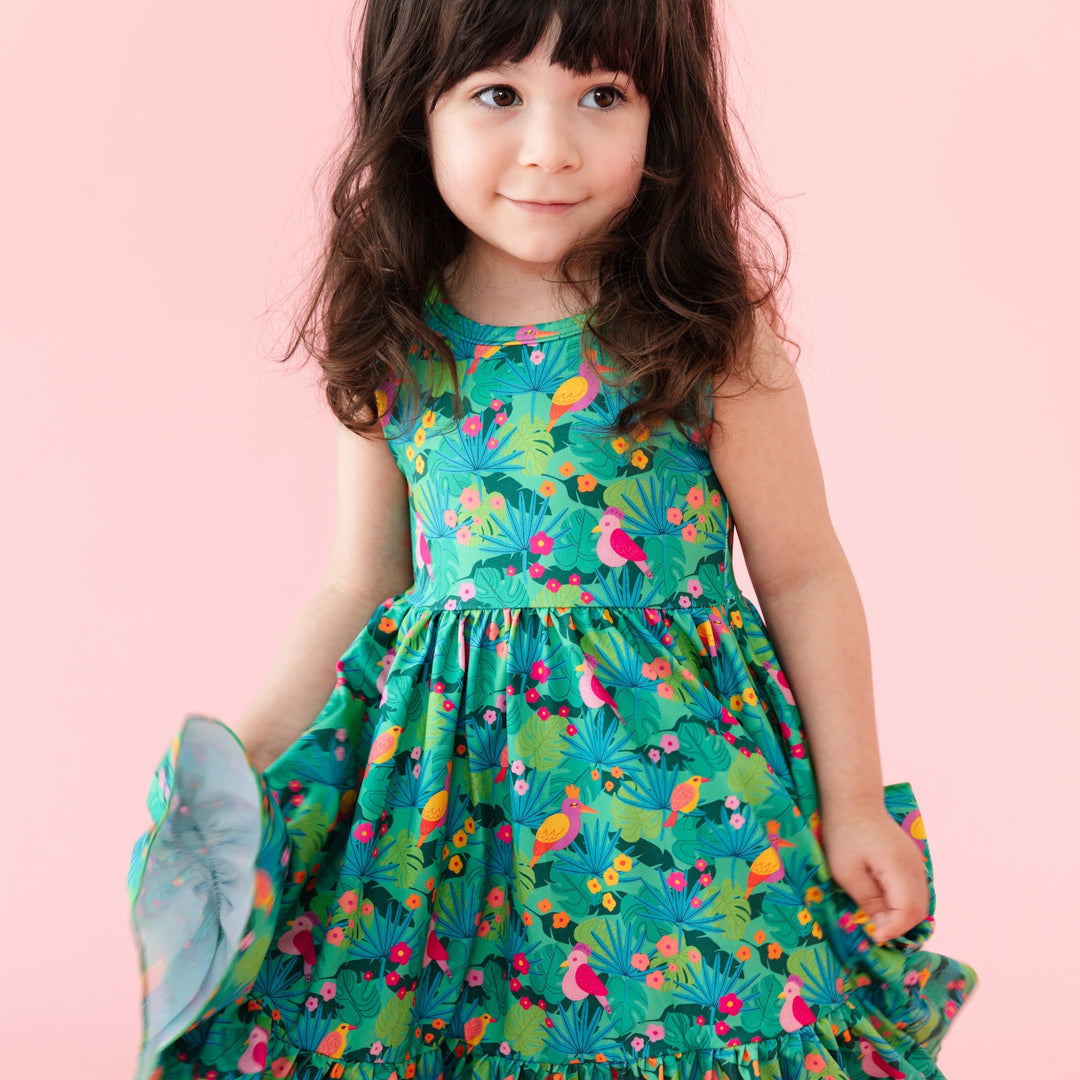little girl wearing green tropical bird print summer dress