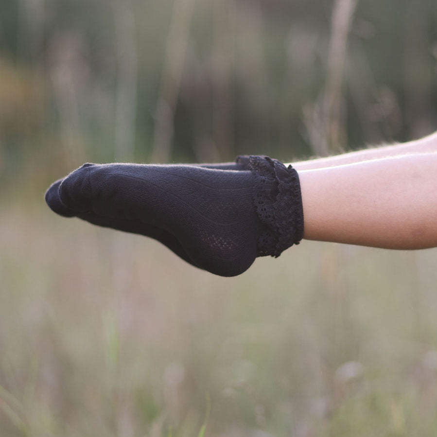 black lace ruffle fancy socks on little girls feet