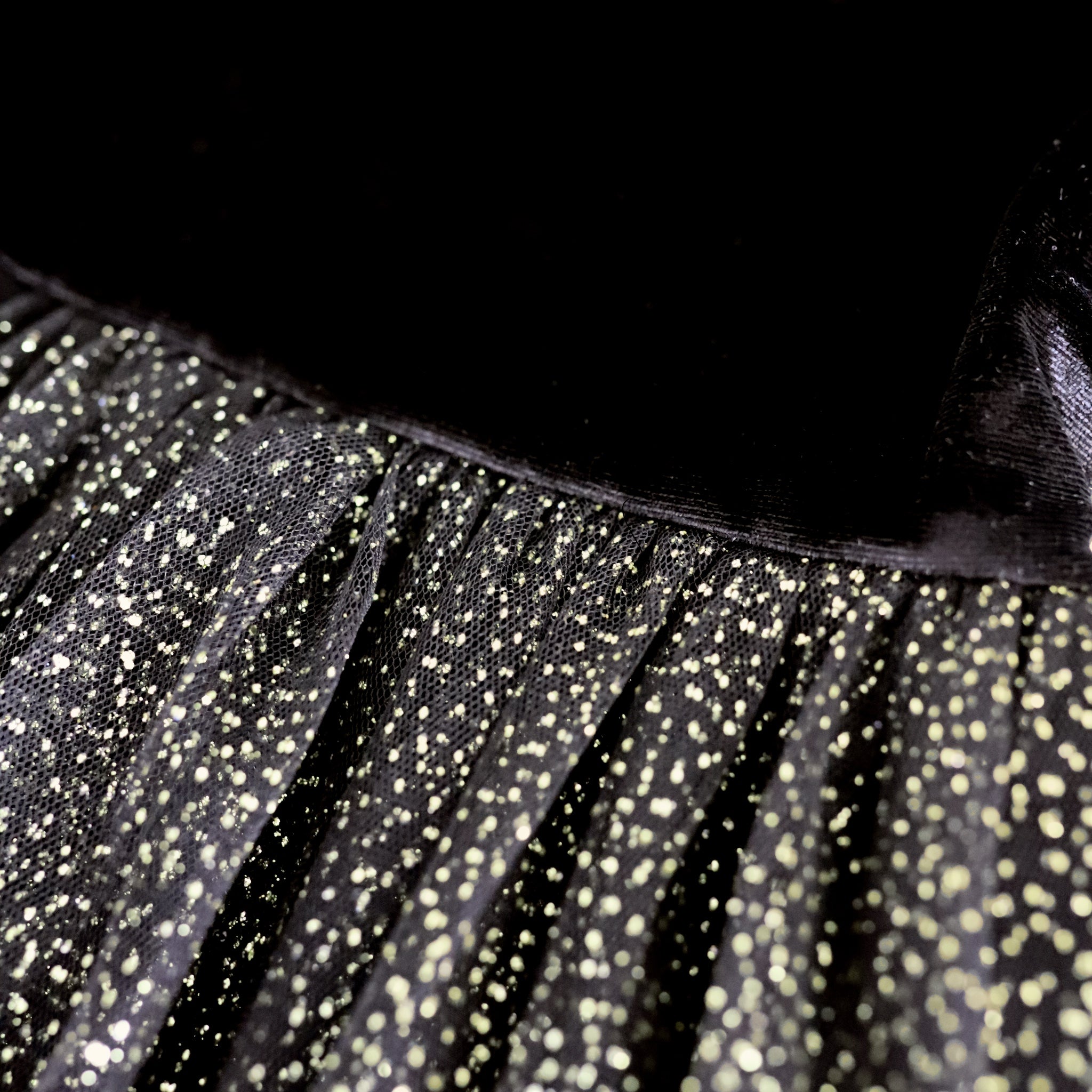 detail photo of girls party dress with black velvet top and gold sparkle tulle tutu skirt