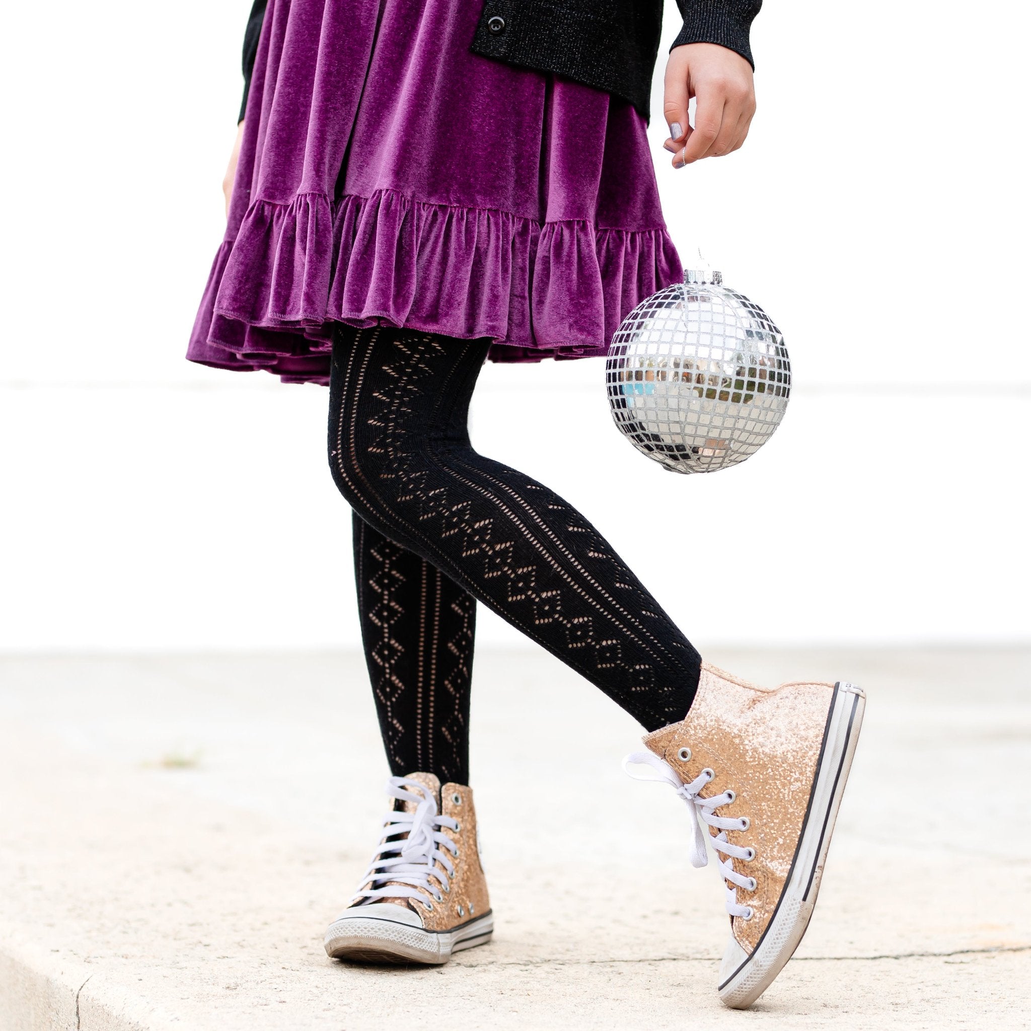 girls open knit tights in black paired with purple velvet dress and gold shoes for New Years Eve party