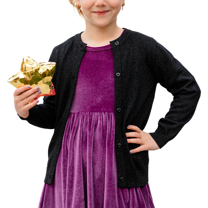 little girl in purple velvet dress and sparkly black button front cardigan for New Years