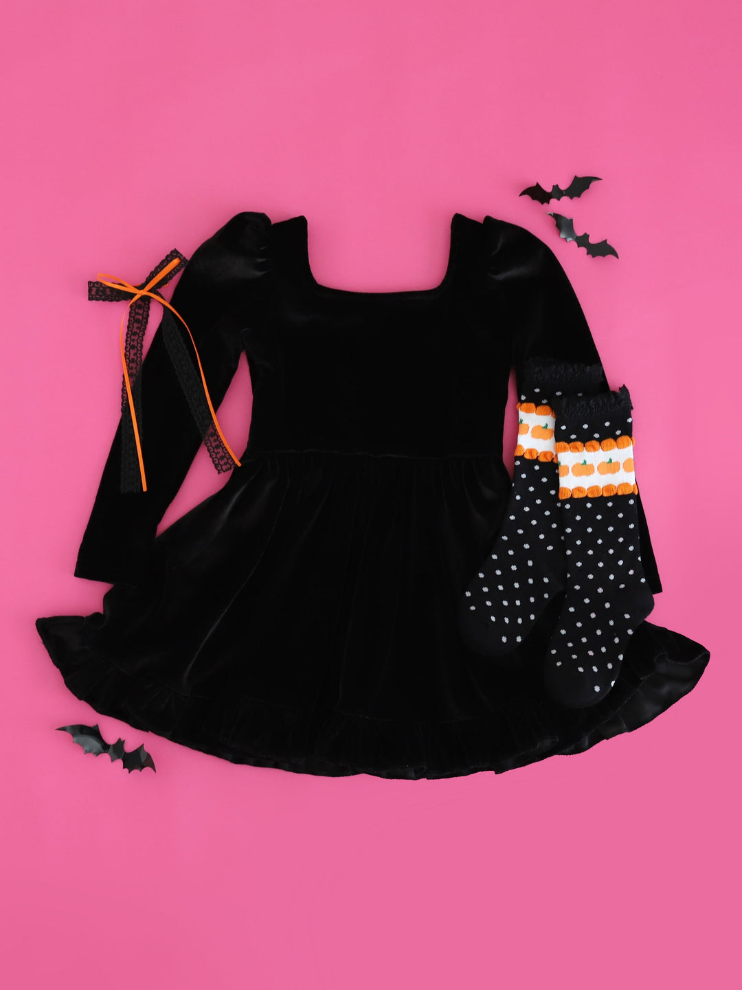 flat lay photo on bright pink background featuring girls&