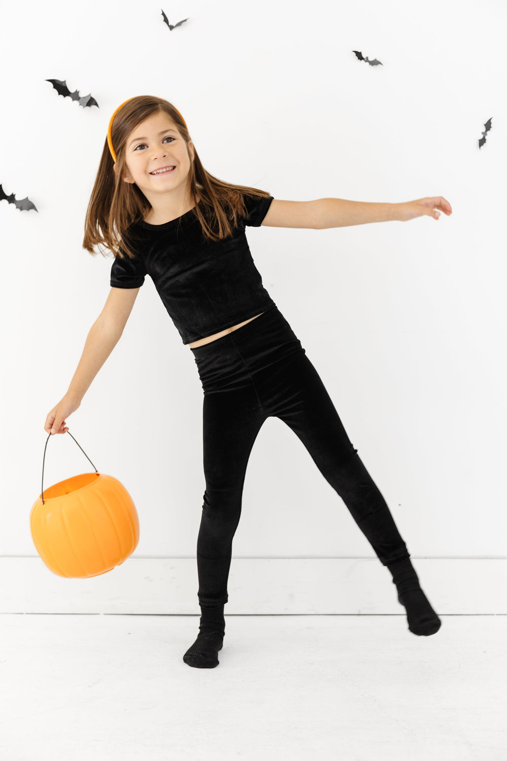 little girl in black velvet fitted top and lettings set for Halloween