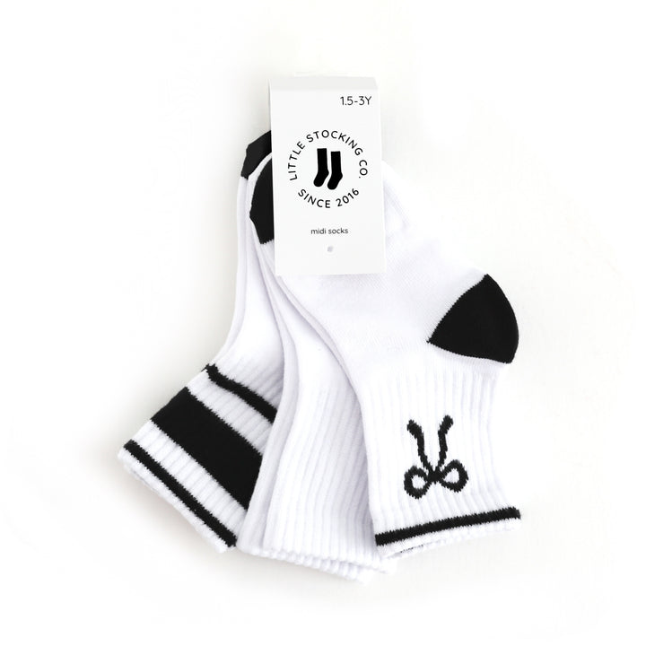 tagged three pack of girl's crew socks with designs in black and white