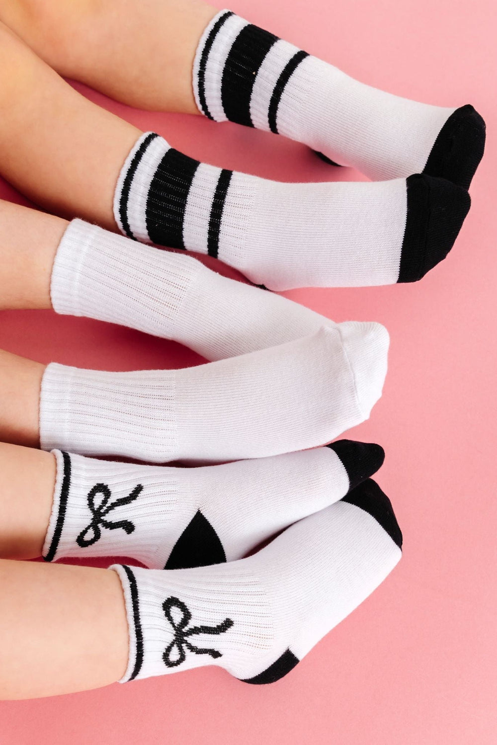 three girls in white with black bow, solid white and white with black stripe midi sock three pack