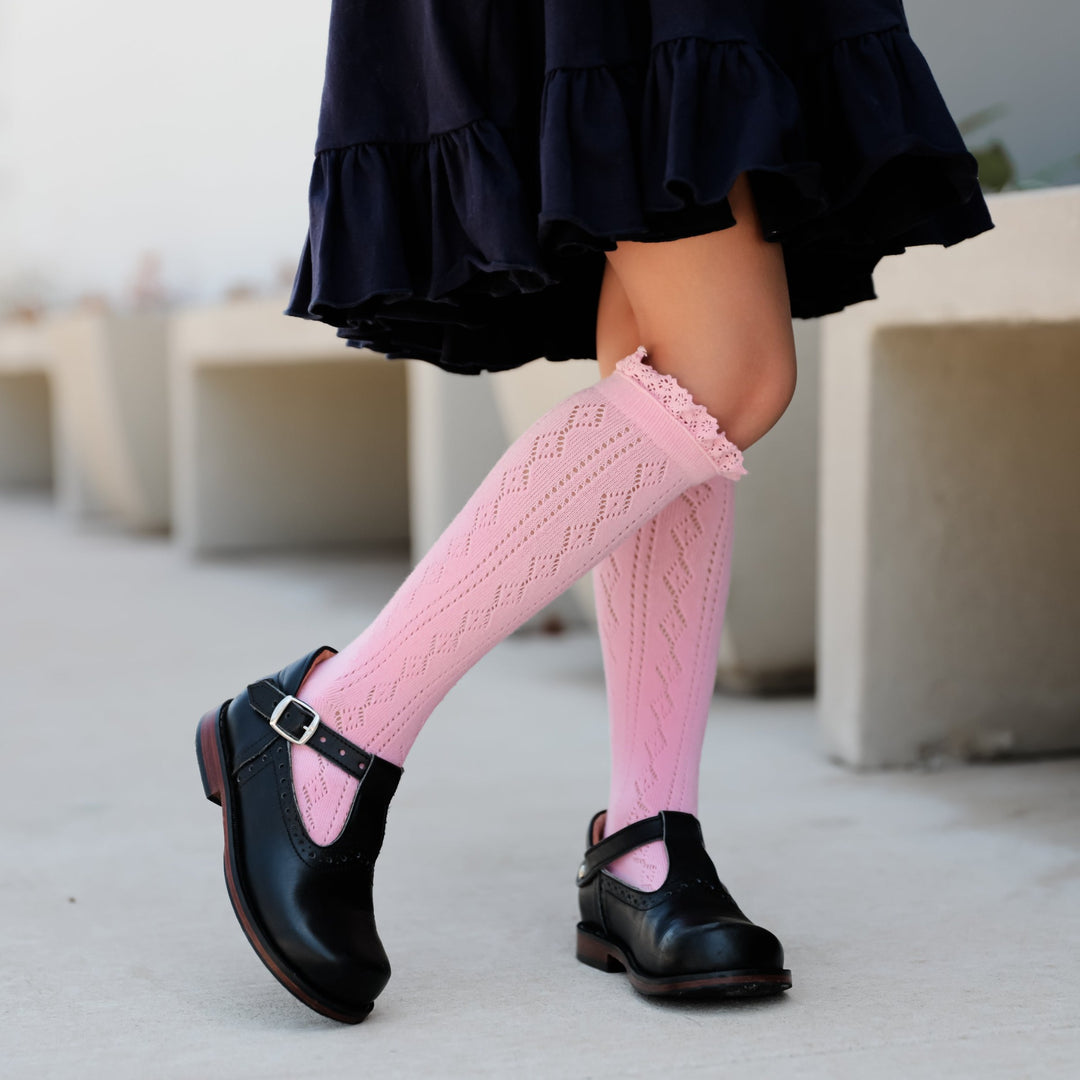 little girl wearing blossom pink fancy crochet knit knee high socks