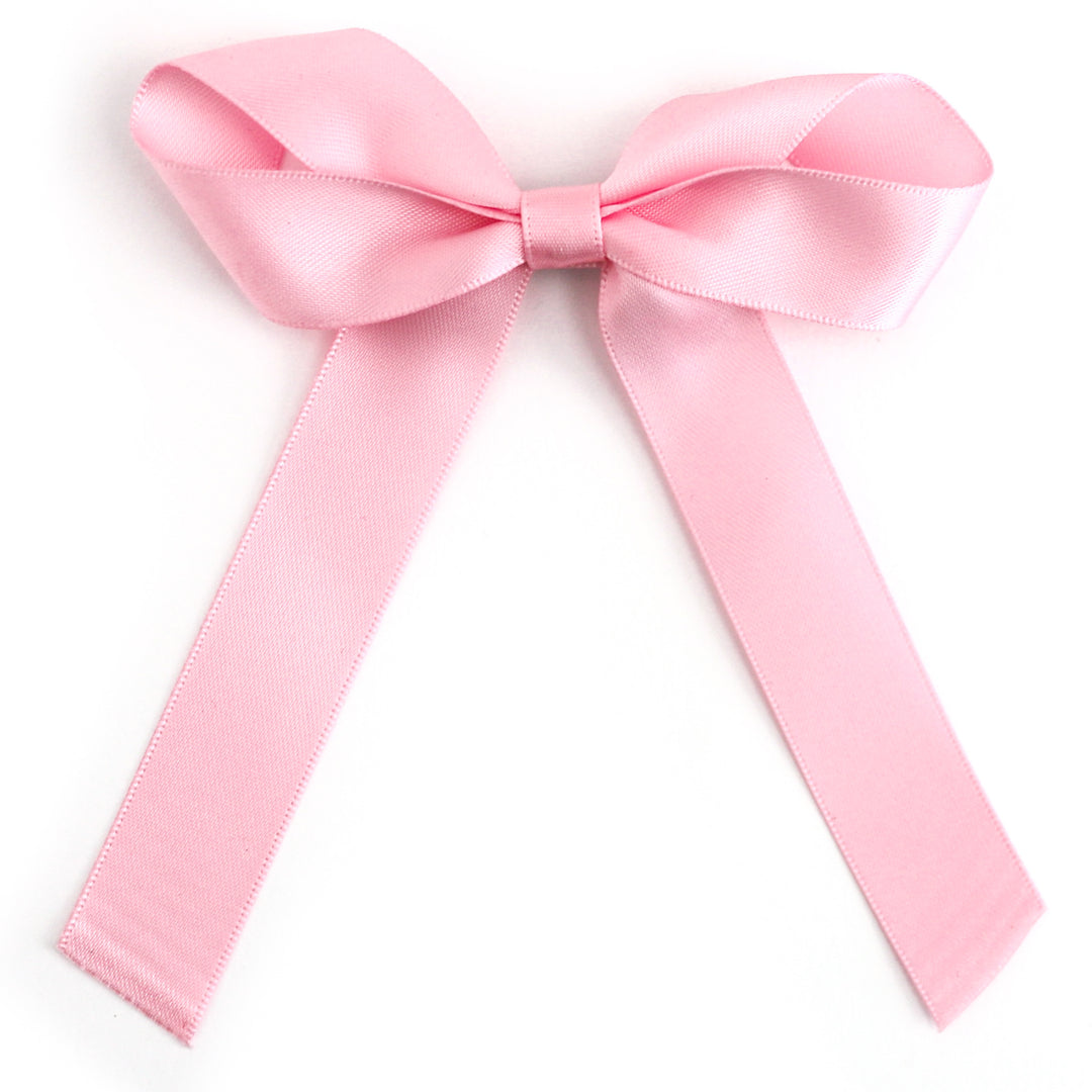 Pink satin bow on a white background