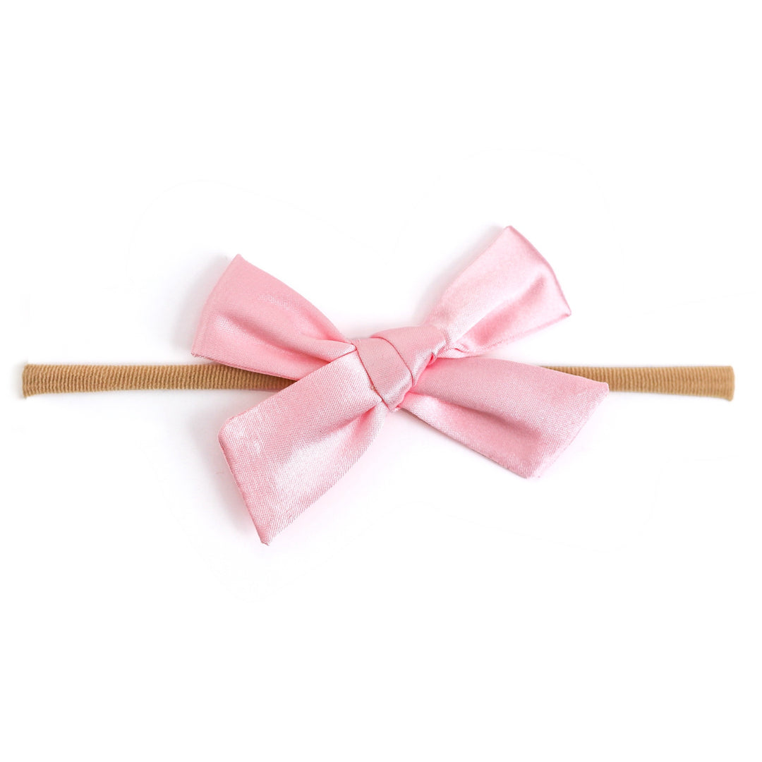 light pink satin hair bow on nylon band for baby girl