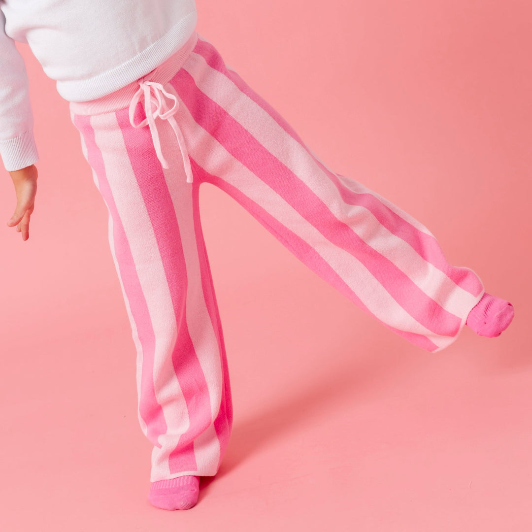girl in two tone pink striped cotton knit sweater pants and pink socks
