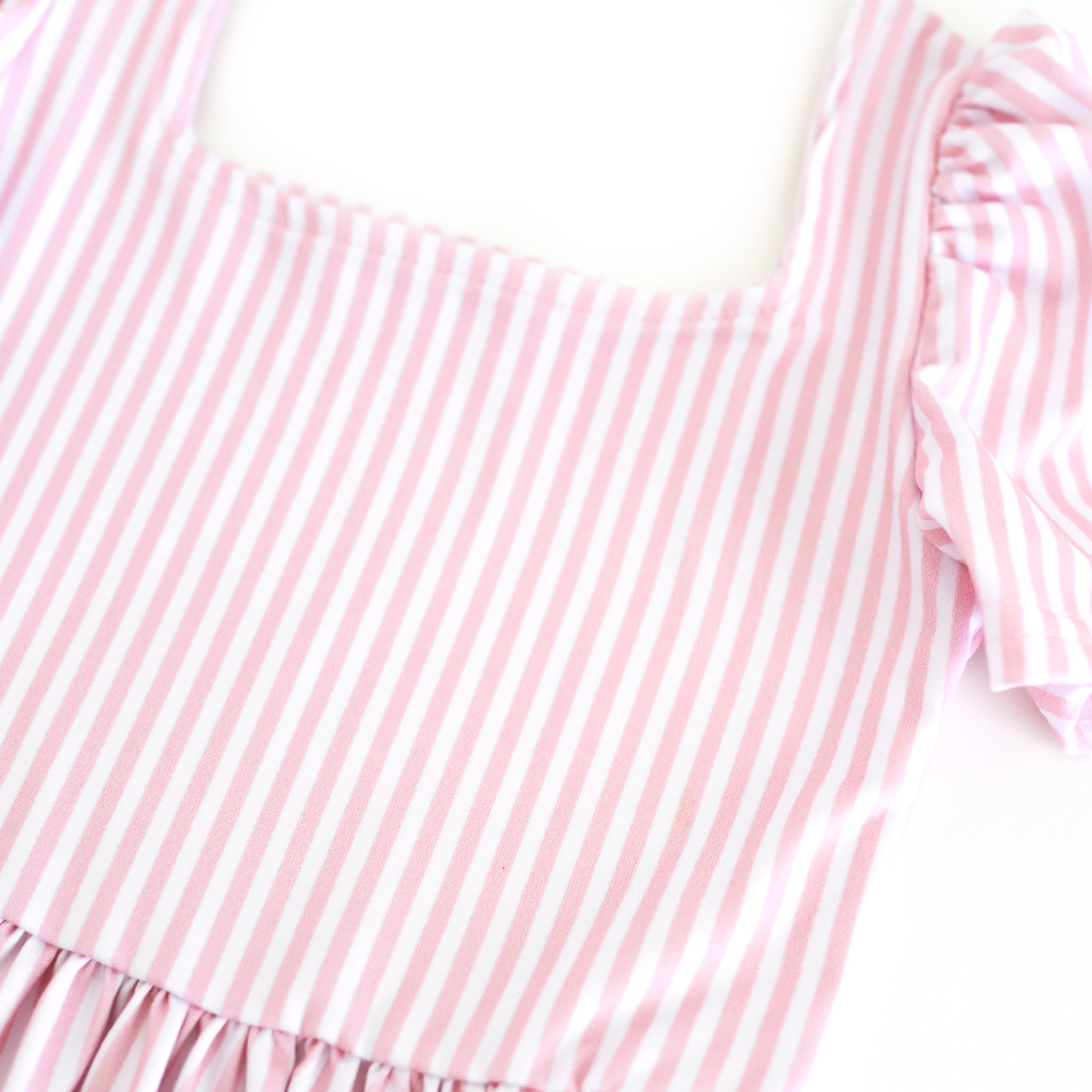 closeup of pink and white pinstripe print on girls' twirl dress bodice