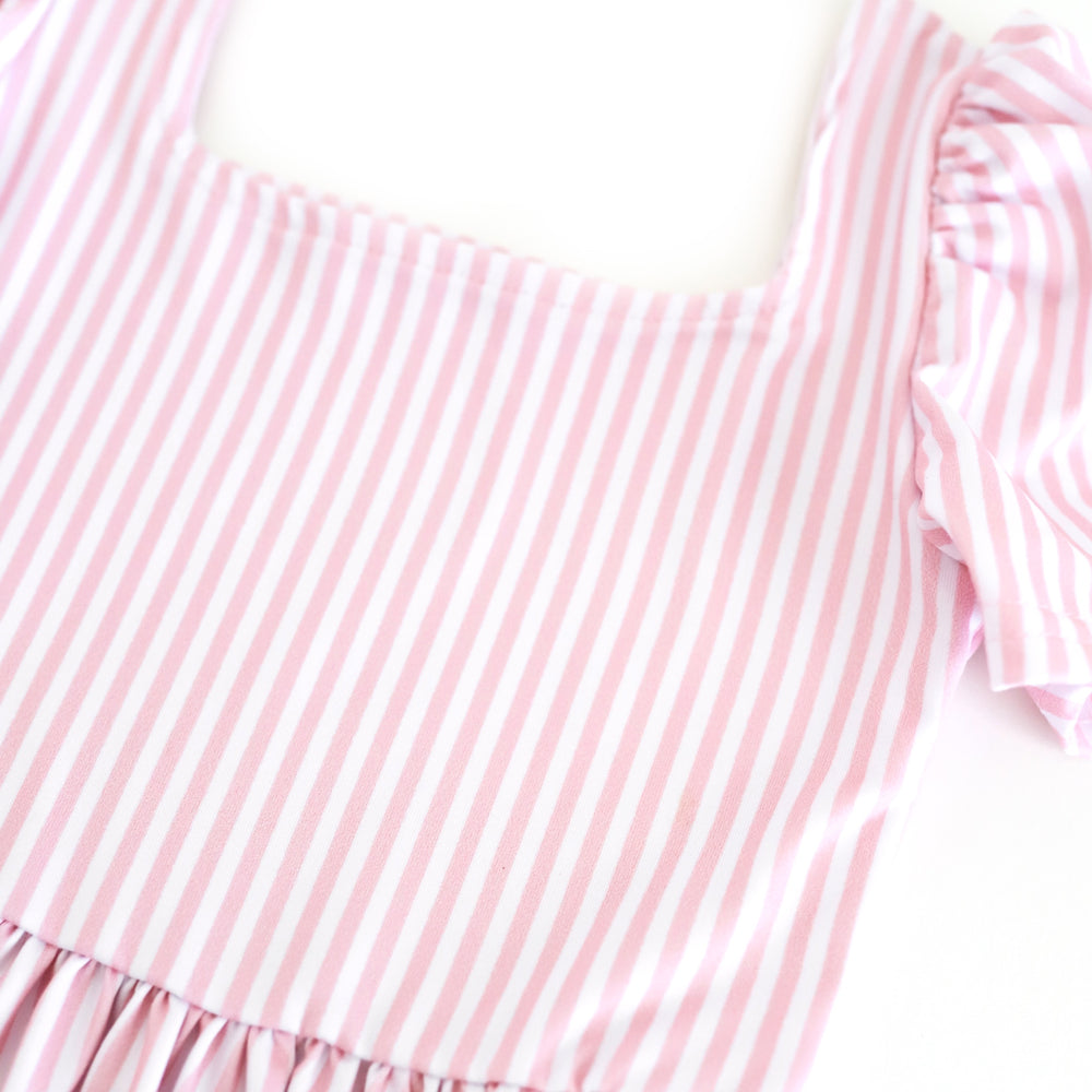 closeup of pink and white pinstripe print on girls' twirl dress bodice