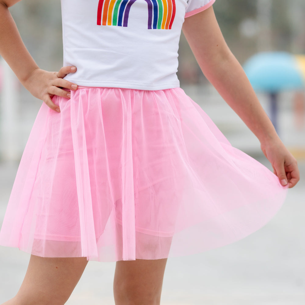 little girl in pink tulle skirt with built in pink shorts paired with charm tee for summer
