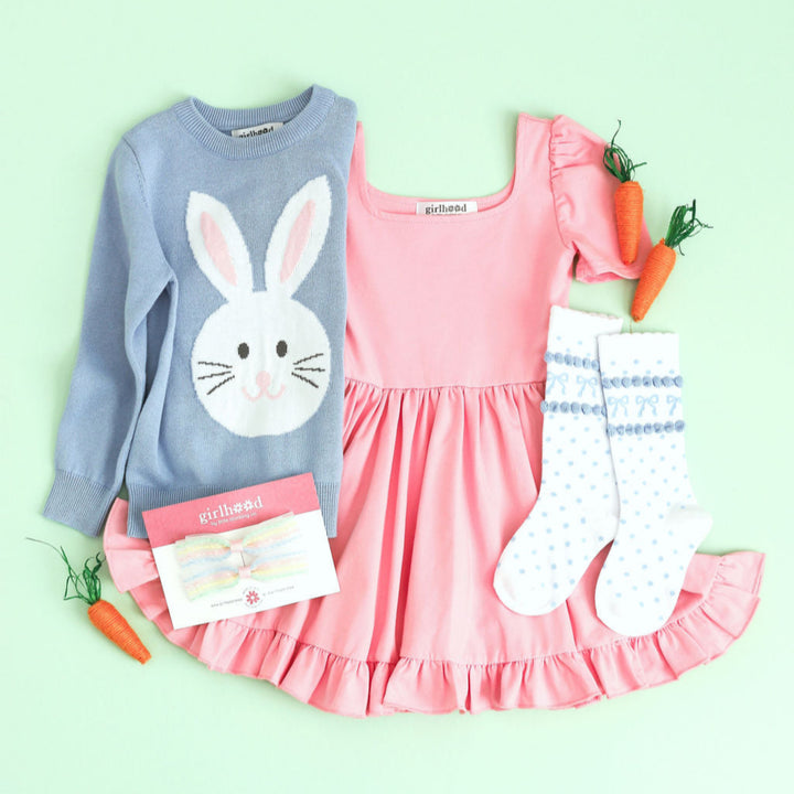 girls' styled easter look featuring blue cotton knit sweater with bunny design, pink cotton square neck twirl dress, pastel striped pigtail bows and white. knee high socks with clue bow and polkadot print 