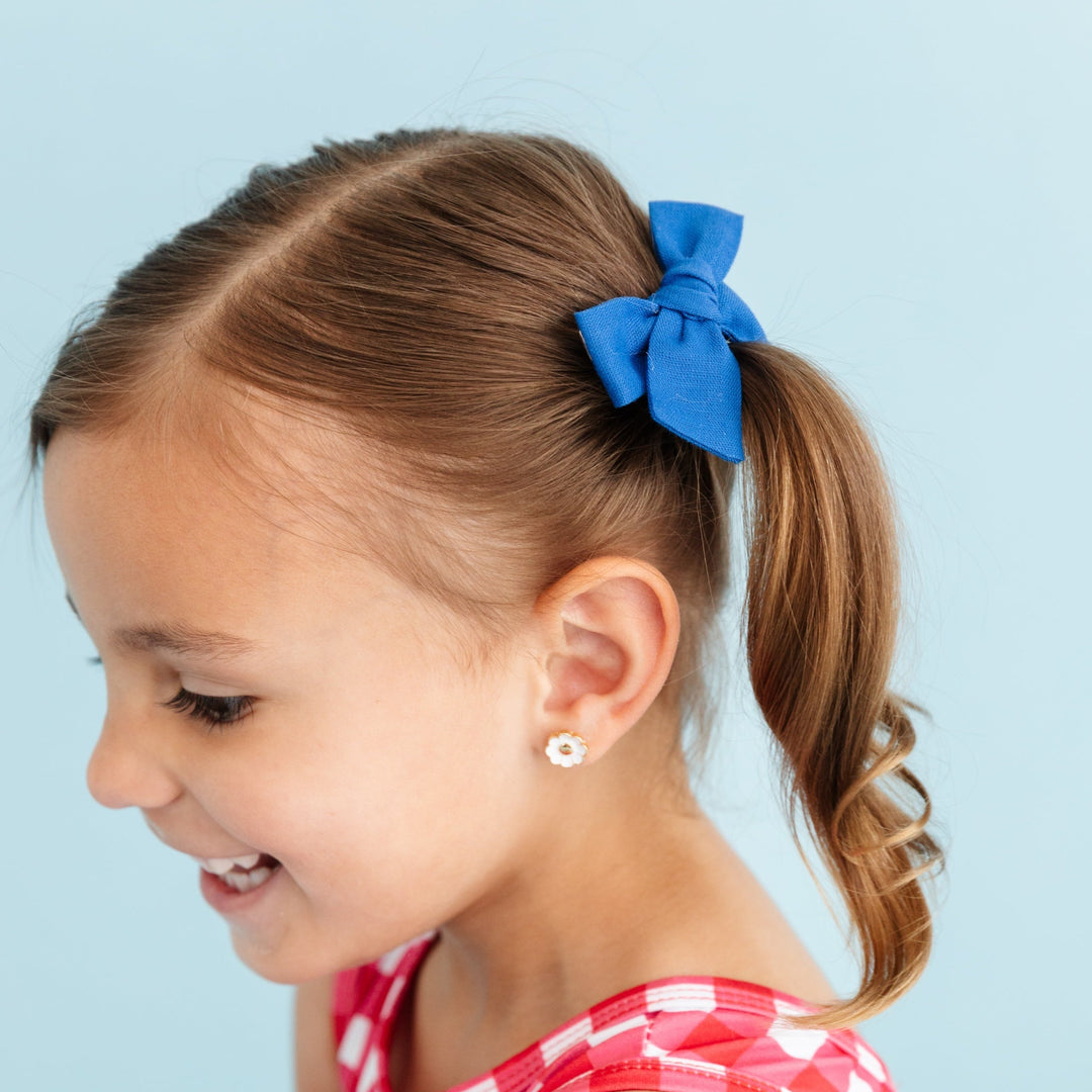little girl wearing true blue linen pigtail bows and 4th of july dress