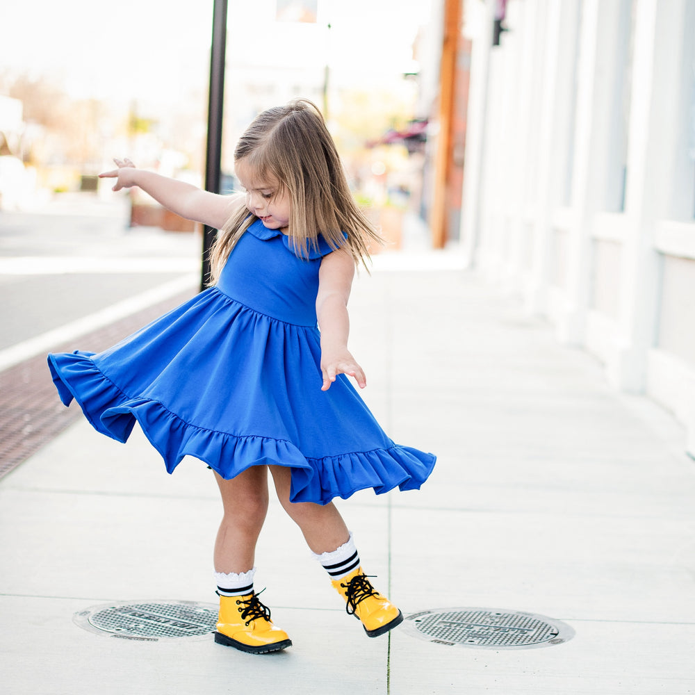 little girl twirling in royal blow summer tank dress