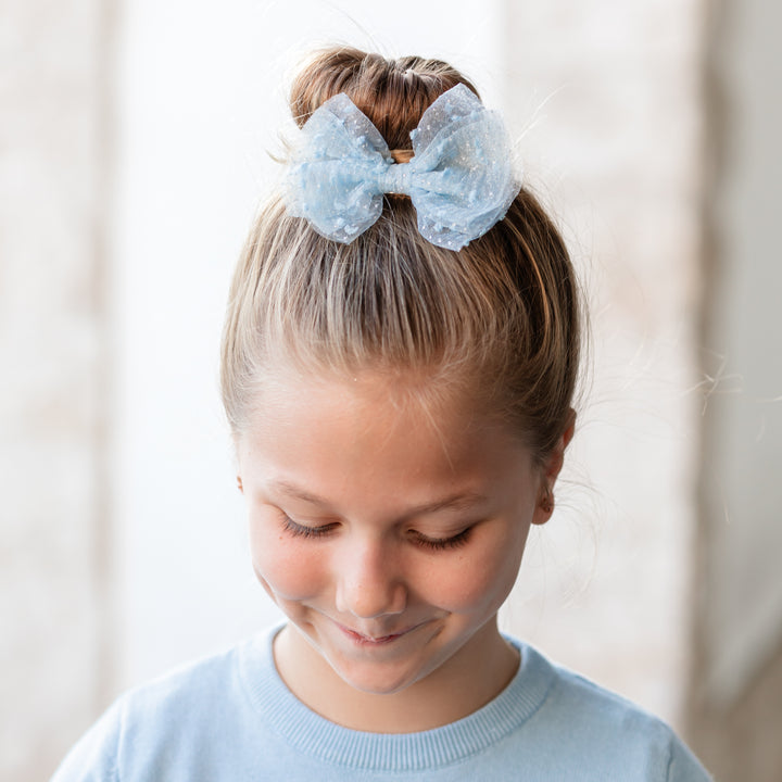 girl in light blue sheer tutu bow for christmas