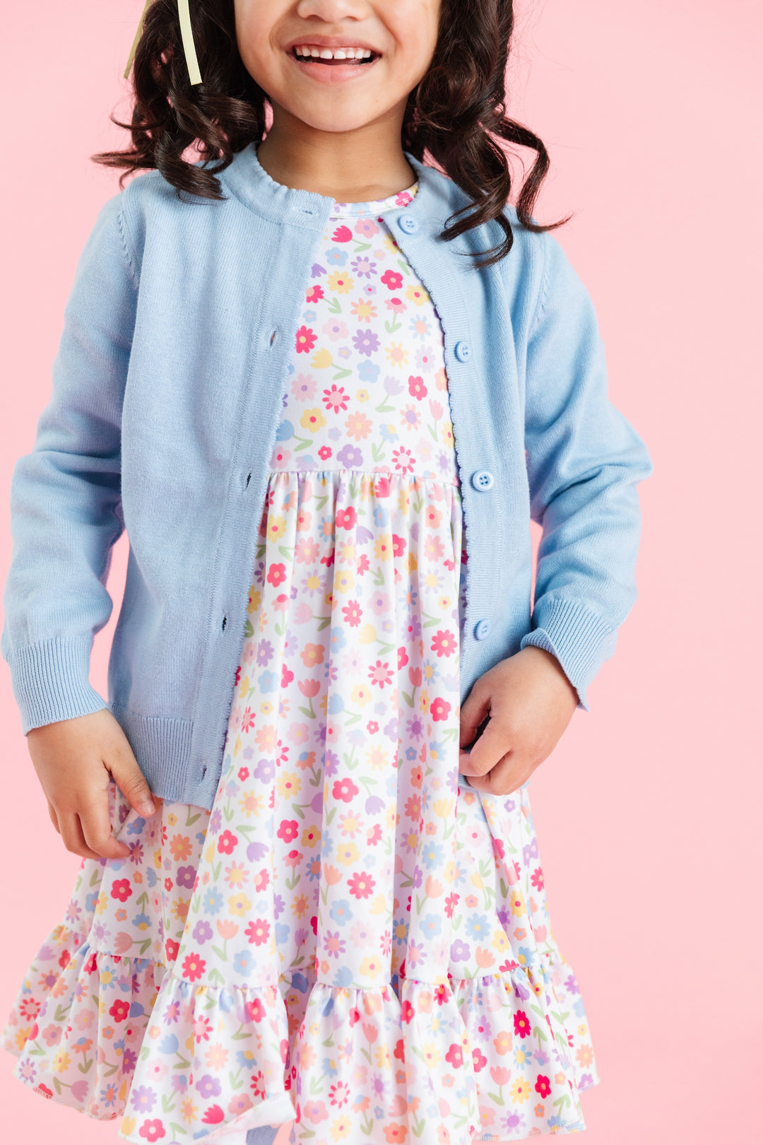 little girl in white floral twirl dress paired with blue cotton knit button up cardigan for spring