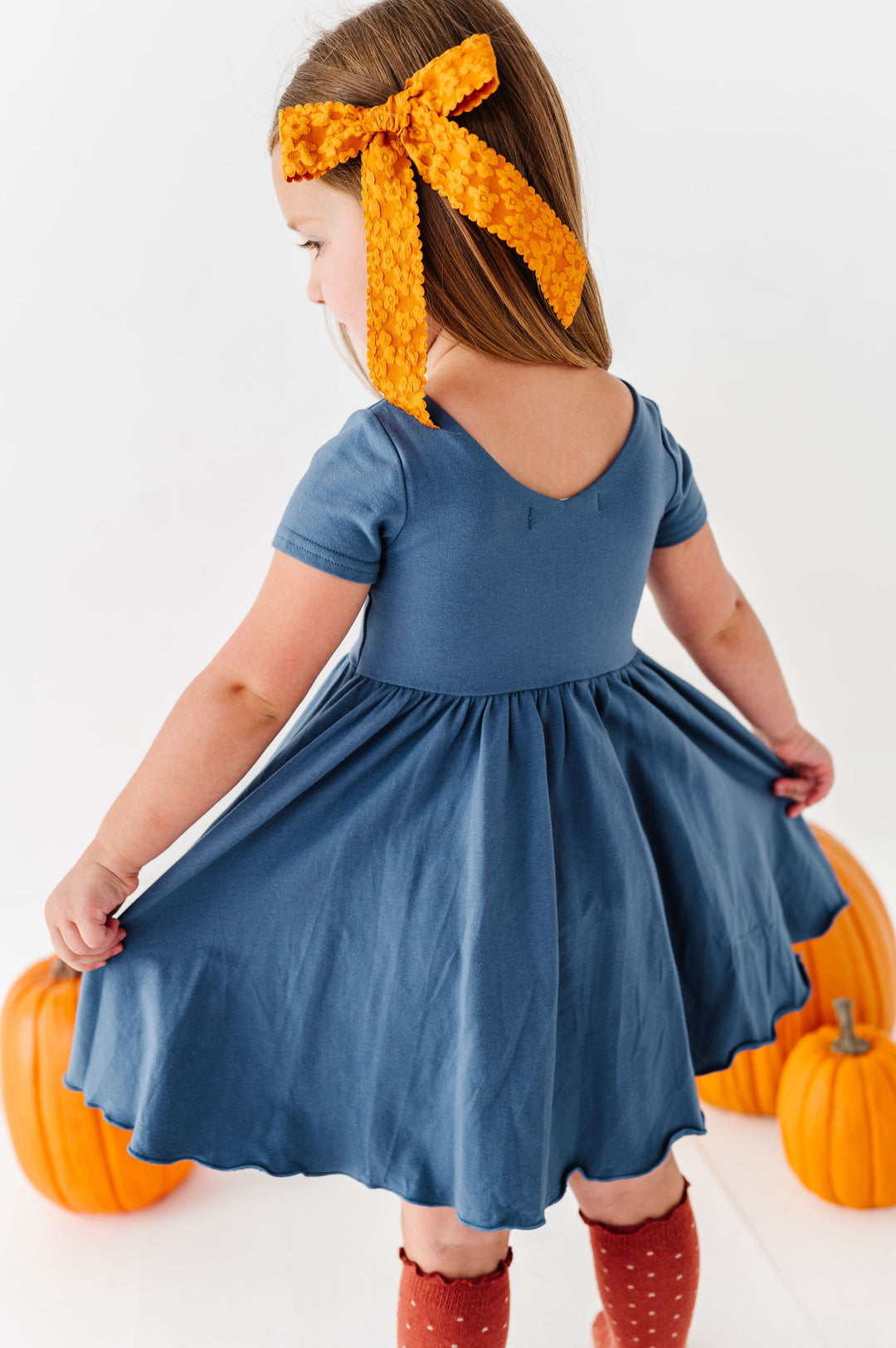 back detail of girls blue twirl dress