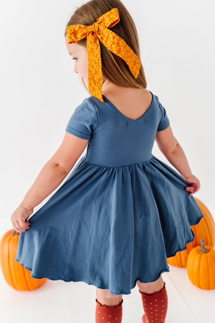 back detail of girls blue twirl dress