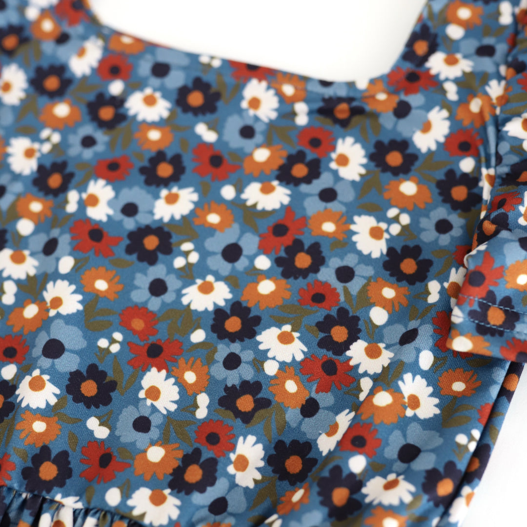 print detail photo of blue twirl dress bodice with petite flowers in shades of blue, mustard, rust and ivory