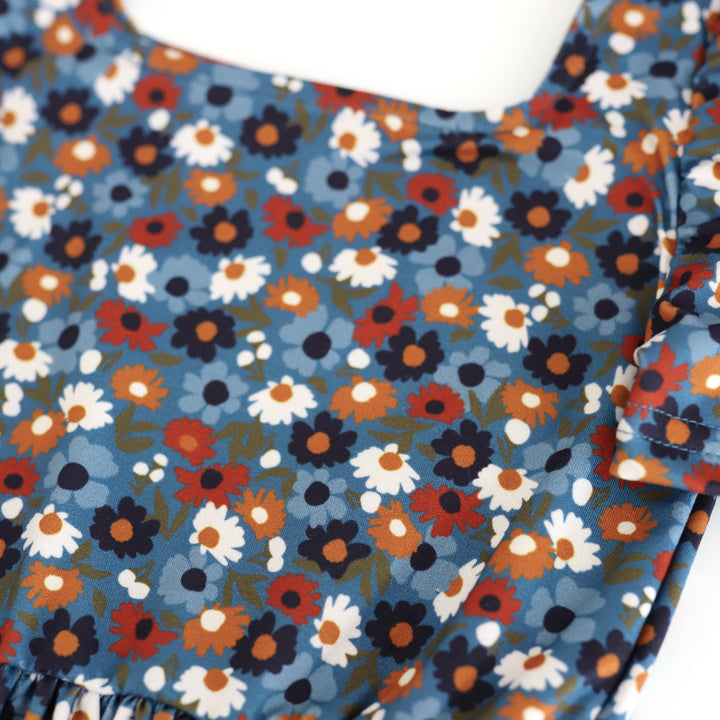 print detail photo of blue twirl dress bodice with petite flowers in shades of blue, mustard, rust and ivory