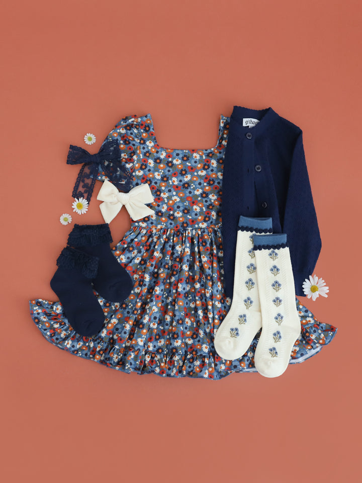 girls blue fall floral twirl dress paired with navy blue cardigan and socks and bows in shades of blue and ivory to match