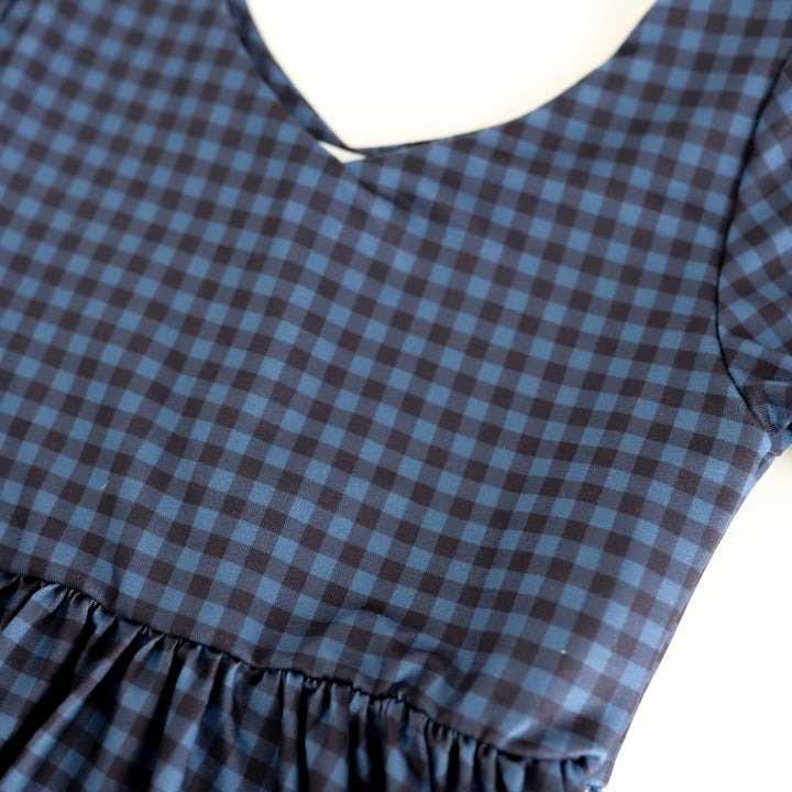 closeup of v-neck twirl dress in two-tone blue gingham print