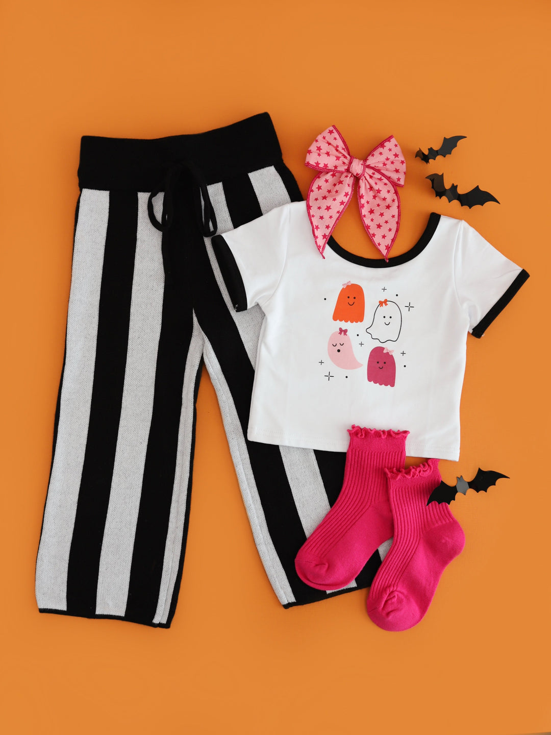 girls' white fitted tee with ghost print, matching black and white sweater pants, pink star bow and pink midi socks