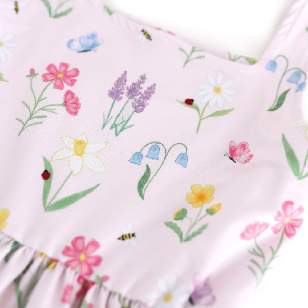 closeup of girls' botanical floral print twirl dress with lady bugs, butterflies and bees