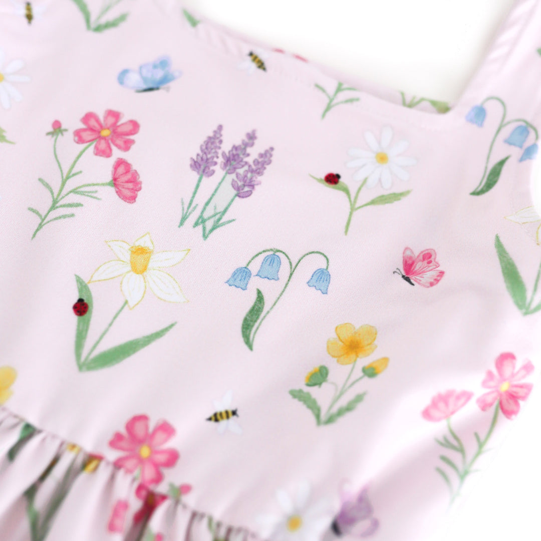 closeup of girls' botanical floral print twirl dress with lady bugs, butterflies and bees