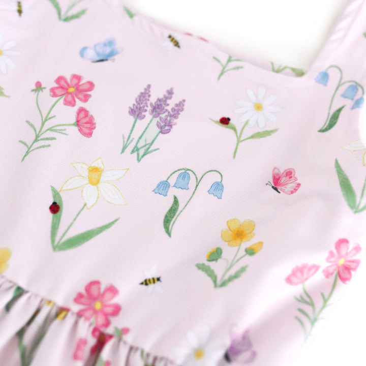 closeup of girls' botanical floral print twirl dress with lady bugs, butterflies and bees