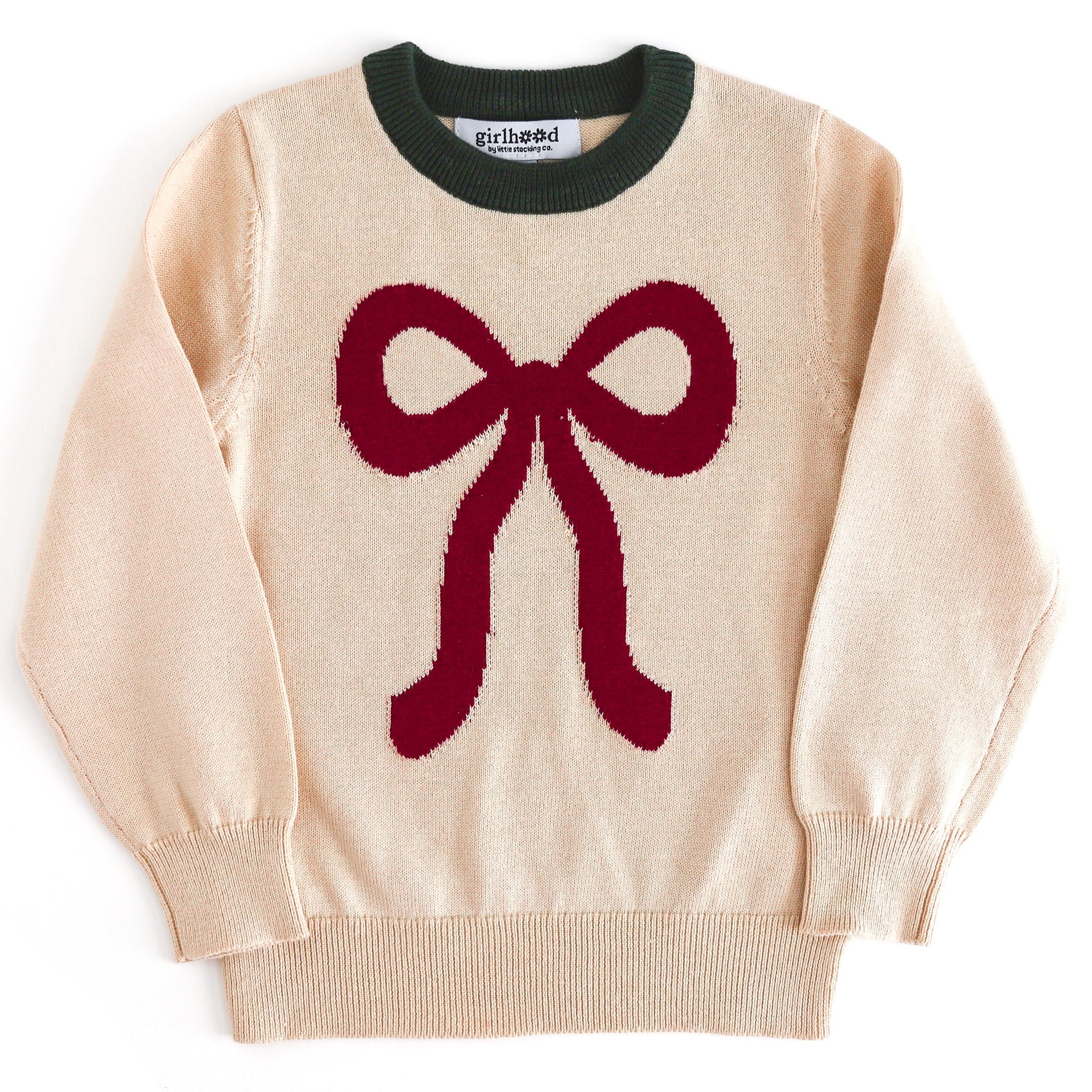 girls cream Christmas sweater with forest green trim at the neckline and large crimson ribbon design 