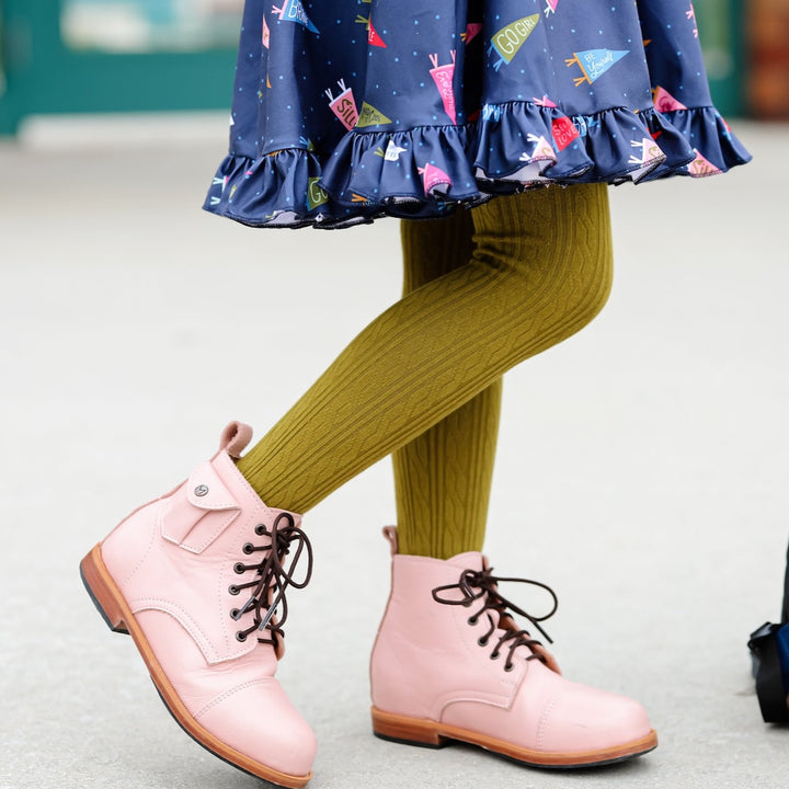 bright olive green tights on girl wearing navy dress and pink boots
