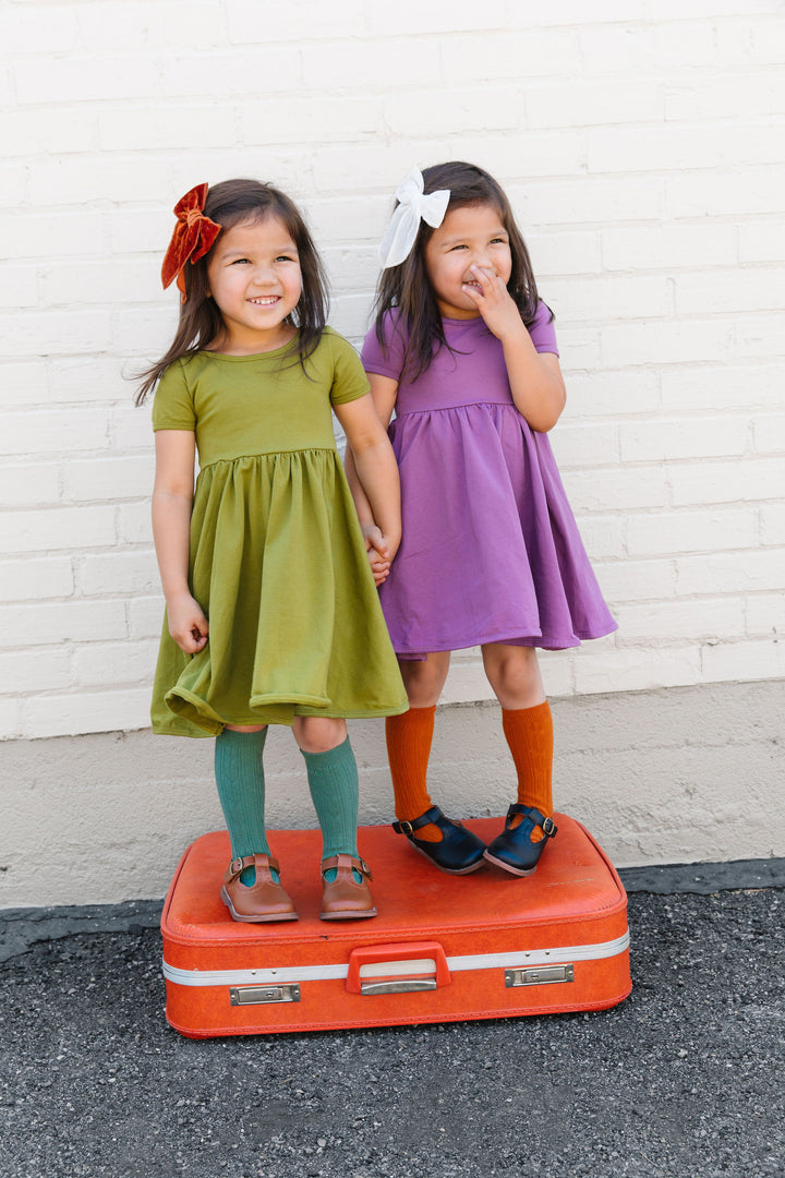 girls colorful dresses and knee high socks