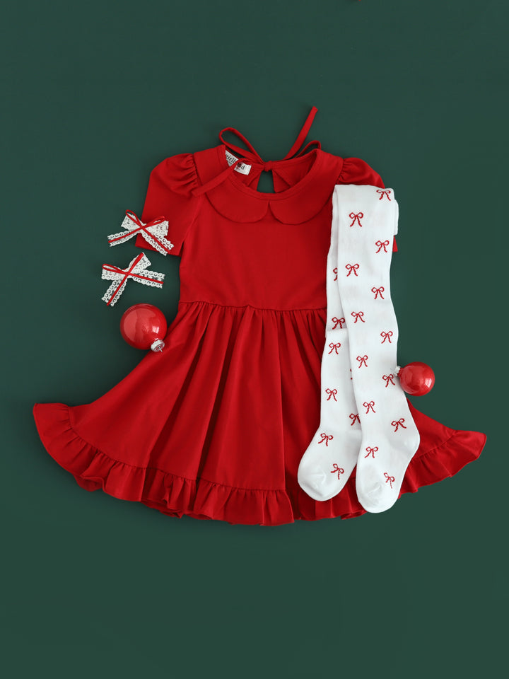 girls red Christmas twirl dress paired with white bow tights and white lace pigtail bows with dainty red ribbon