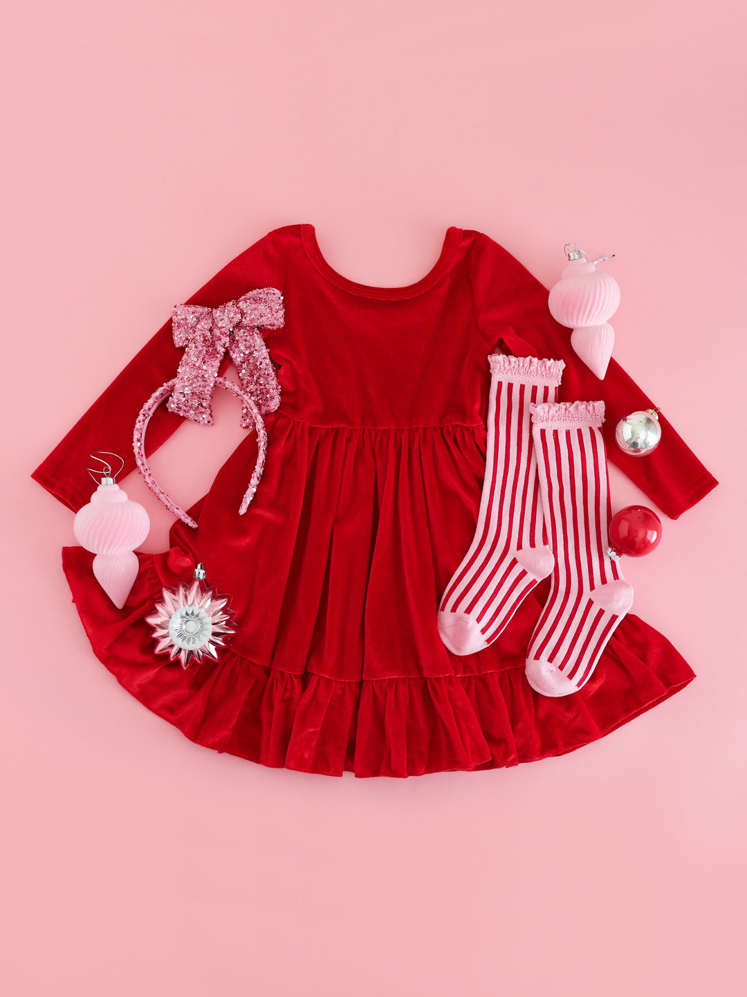 girls' red velvet long sleeve twirl dress with sparkly pink hair accessories and red and pink striped knee socks for Christmas