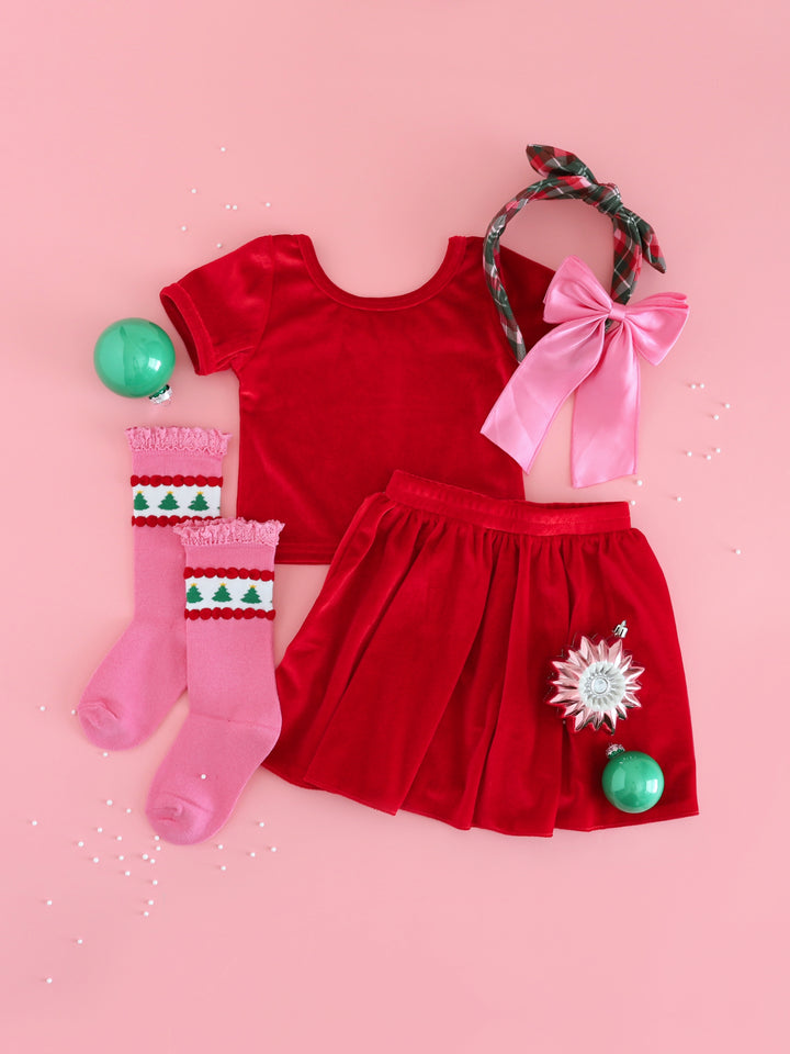 girls' matching bright red velvet top and skirt paired with pink Christmas knee socks and bow