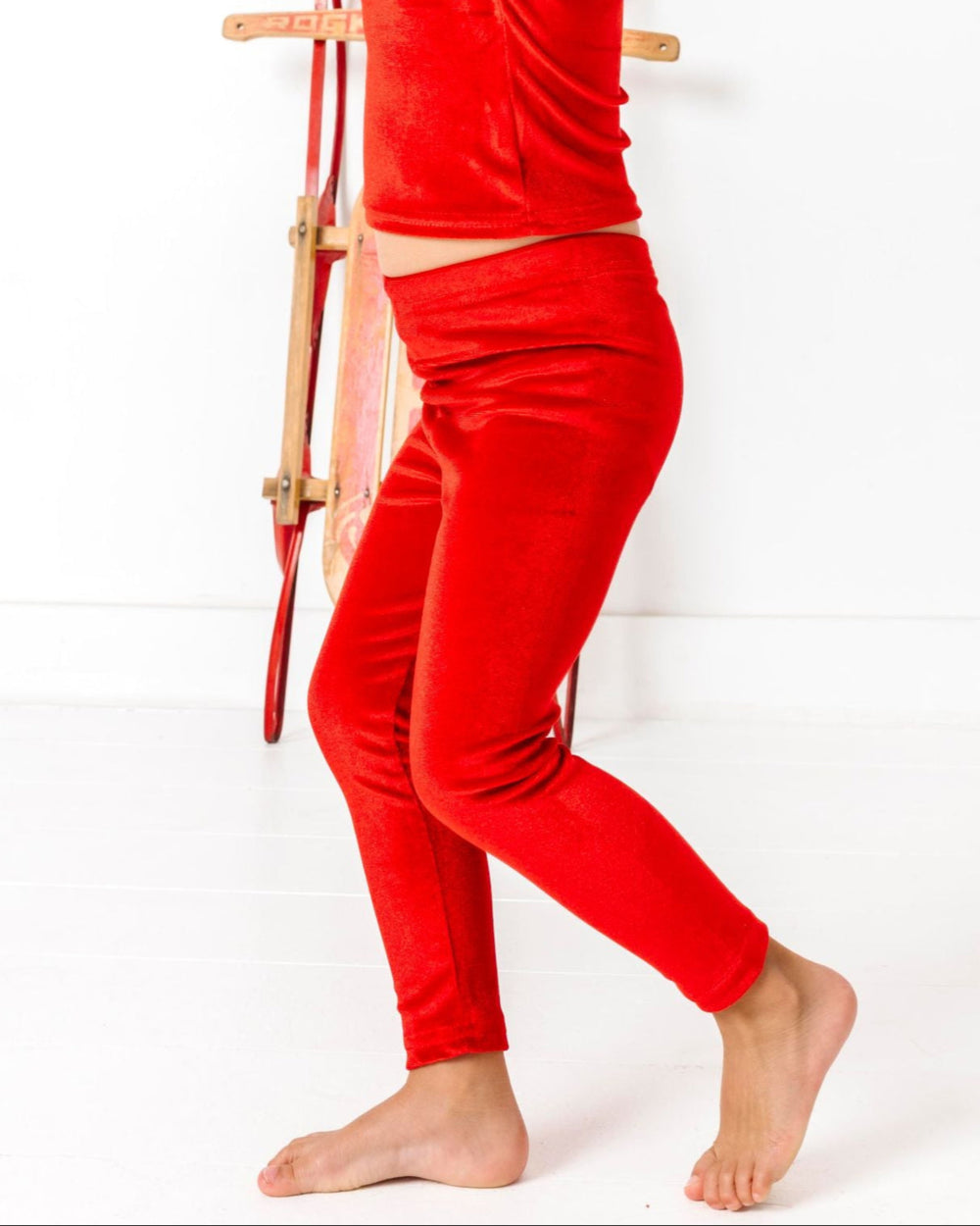 little girl in bright red velvet leggings for Christmas