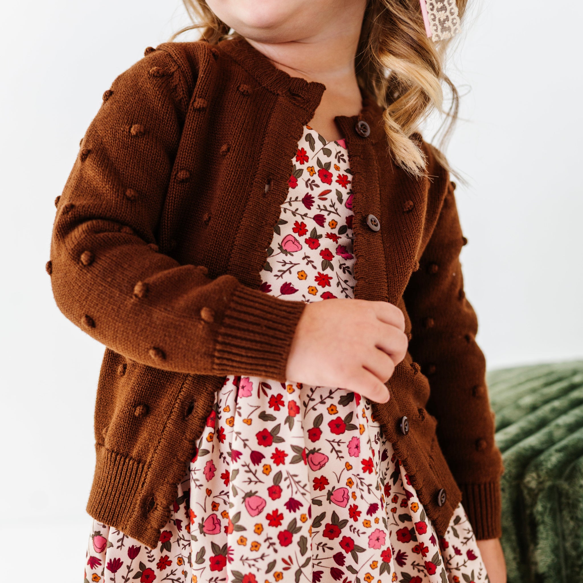 little girl in fall floral dress and brown knit cardigan with 3D bubble textrue